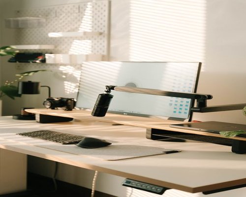 Ergonomic desk setup with a monitor at eye level and natural light
