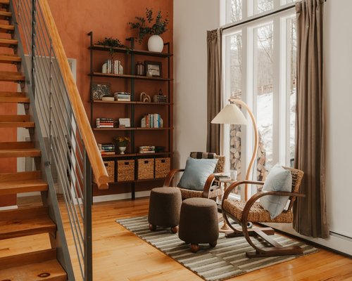 Living room with sheer curtains diffusing bright sunlight onto a reading chair