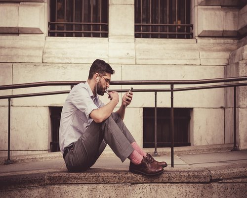 Person typing on smartphone while commuting on a crowded city bus